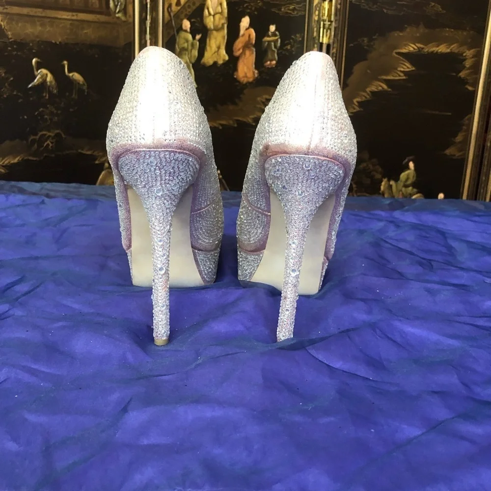 Size 9.5 Steve Madden, rhinestone platform pumps.